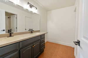 Basement bathroom with dual vanity.  Seperate shower and toilet rooms