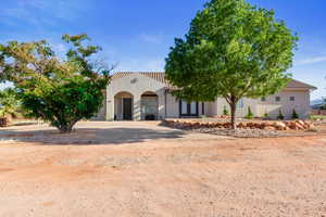 Mediterranean / spanish-style home with a garage