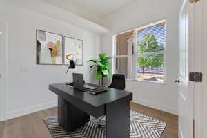 Home office in front of home by entryway. Virtually Staged