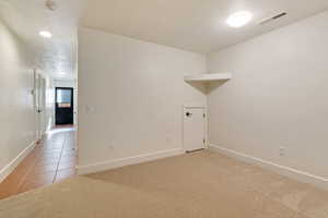 View of basement family room and exterior door