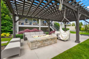 View of patio / terrace with a pergola and an outdoor living space with a fire pit