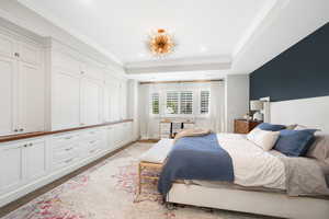 Bedroom featuring ornamental molding and a tray ceiling