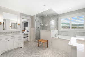 Bathroom featuring tile floors, independent shower and bath, and large vanity