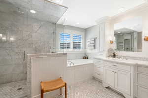 Bathroom featuring tile flooring, independent shower and bath, and vanity with extensive cabinet space