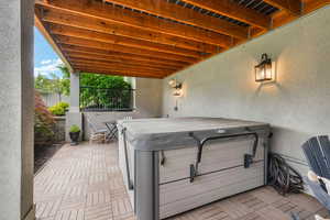 View of terrace featuring a hot tub