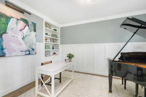 Carpeted office featuring crown molding and built in features