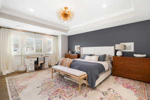 Bedroom featuring ornamental molding and a raised ceiling