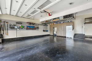 Garage featuring white fridge and a garage door opener