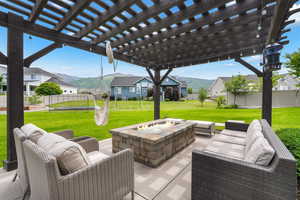 View of patio with a pergola and an outdoor fire pit