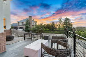 Patio terrace at dusk featuring a balcony