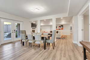 Dining room featuring french doors and light wood-type flooring