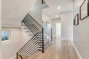 Stairs featuring light hardwood / wood-style flooring