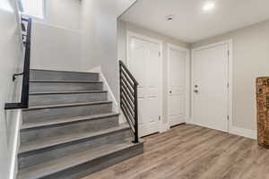 Stairs with hardwood / wood-style floors