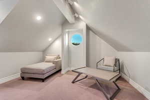 Sitting room with lofted ceiling and carpet