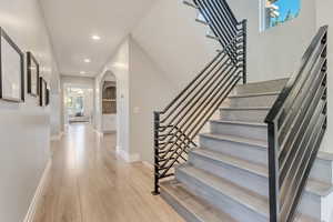 Stairs with light hardwood / wood-style floors