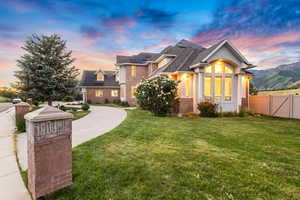 View of front of home featuring a lawn and solar panels