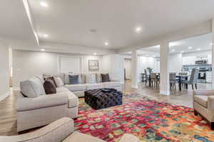 Living room featuring hardwood / wood-style flooring and decorative columns