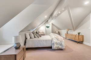 Bedroom with carpet flooring and vaulted ceiling