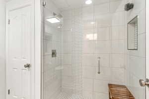 Bathroom featuring a tile shower