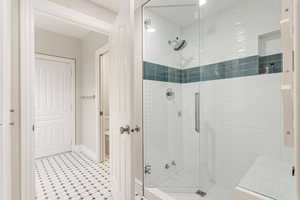 Bathroom with walk in shower and tile flooring