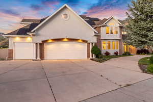 View of property with a garage and solar panels