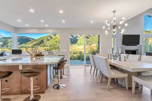 Dining area featuring a mountain view, a chandelier, and light hardwood / wood-style flooring