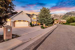 View of front facade with a garage and a mountain view