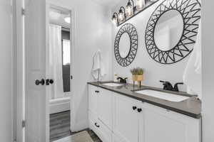 Jack & Jill Bathroom featuring dual sinks, shower / tub combo.