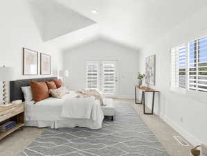 Bedroom featuring light colored carpet, access to exterior, and lofted ceiling