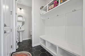 Mudroom featuring dark tile floors