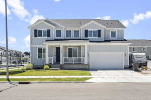 View of front of property with a garage and a front yard