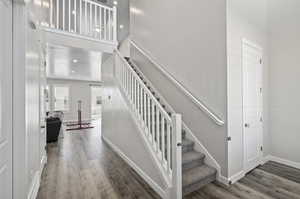 Stairway featuring hardwood / wood-style floors