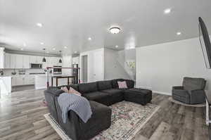 Living room with hardwood / wood-style flooring