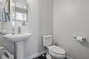 Bathroom featuring tile floors and toilet