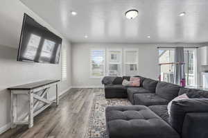 Living room with hardwood / wood-style flooring