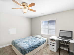 Carpeted bedroom with ceiling fan