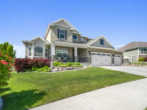 Craftsman-style house with a front yard and covered porch