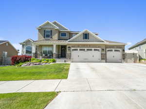 Craftsman-style house featuring a front lawn, a garage, and a porch