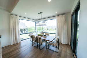 Dining space featuring dark hardwood / wood-style flooring, a chandelier, and plenty of natural light