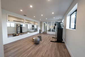 Exercise room with hardwood / wood-style flooring