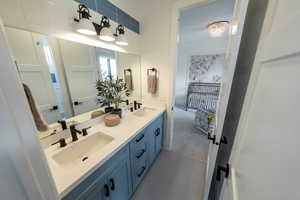 Bathroom featuring tile floors and dual vanity