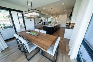 Dining room with sink, a chandelier, and hardwood / wood-style flooring