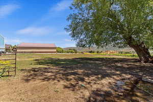 View of yard with a rural view and a playground