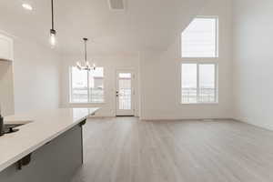 Kitchen featuring a notable chandelier, decorative light fixtures, and light hardwood / wood-style flooring