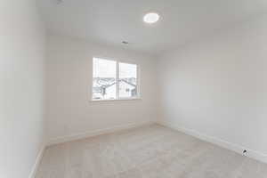 Empty room with light colored carpet