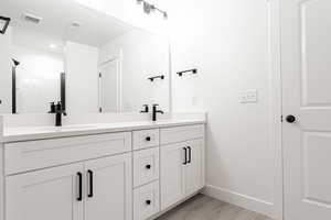 Bathroom featuring wood-type flooring and vanity