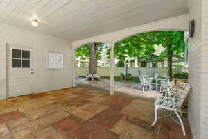 View of covered patio / terrace with garage door access.