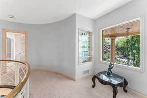 Hall featuring light colored carpet.