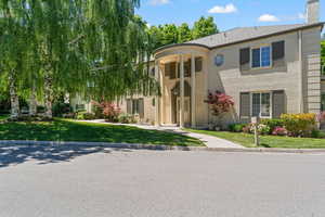 View of front facade with willow tree.