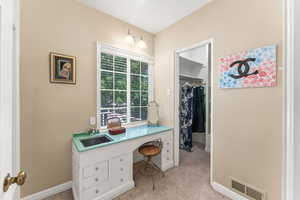 Dressing area with sink adjacent to Primary suite closet.